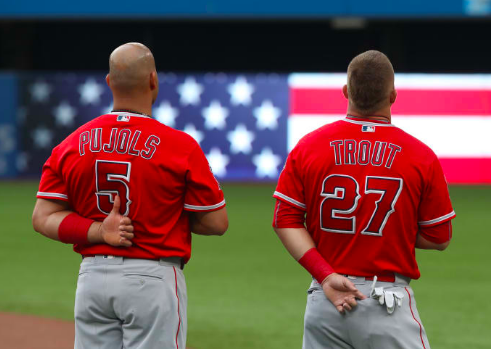 Los Angeles Angels all-star Mike Trout and first baseman Albert Pujols standing for the national anthem.