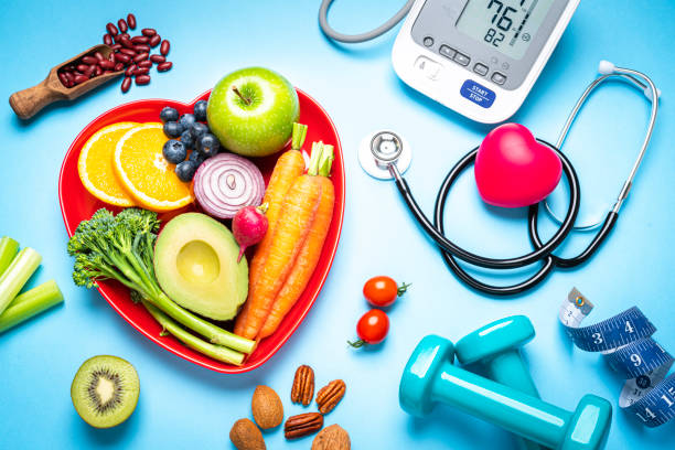 Healthy+lifestyle+concepts%3A+red+heart+shape+plate+with+fresh+organic+fruits+and+vegetables+shot+on+blue+background.+A+digital+blood+pressure+monitor%2C+doctor+stethoscope%2C+dumbbells+and+tape+measure+are+beside+the+plate++This+type+of+foods+are+rich+in+antioxidants+and+flavonoids+that+prevents+heart+diseases%2C+lower+cholesterol+and+help+to+keep+a+well+balanced+diet.+High+resolution+42Mp+studio+digital+capture+taken+with+SONY+A7rII+and+Zeiss+Batis+40mm+F2.0+CF+lens